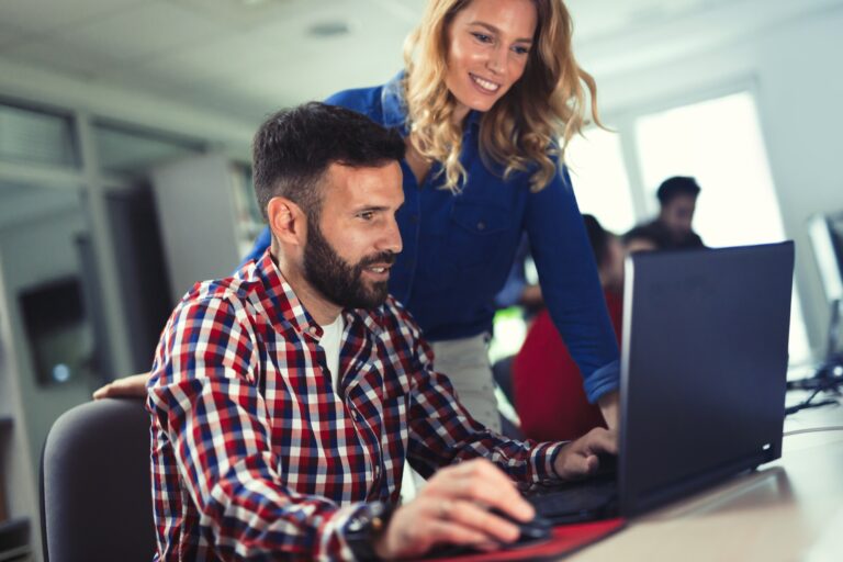 Programmers cooperating at information technology company